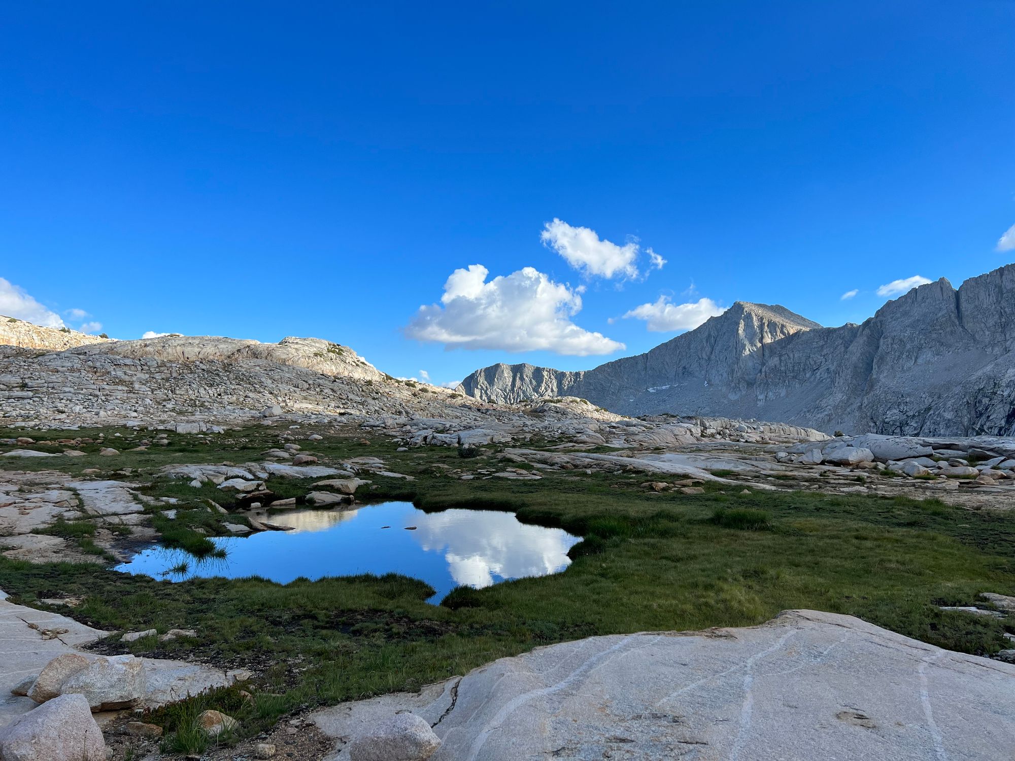 A small puddle of water reflecting the sky.