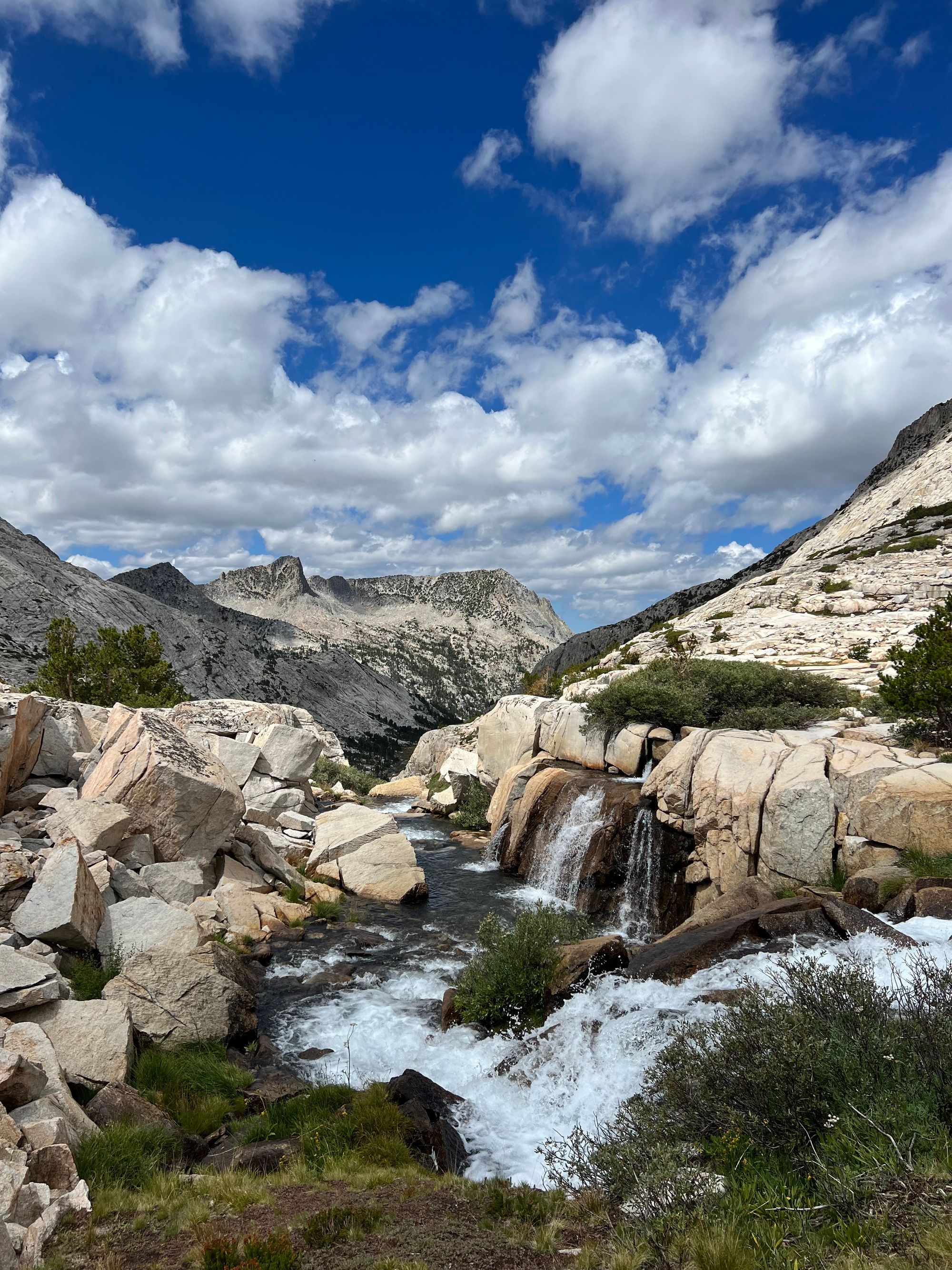 Several small waterfalls flowing into a pool of water.
