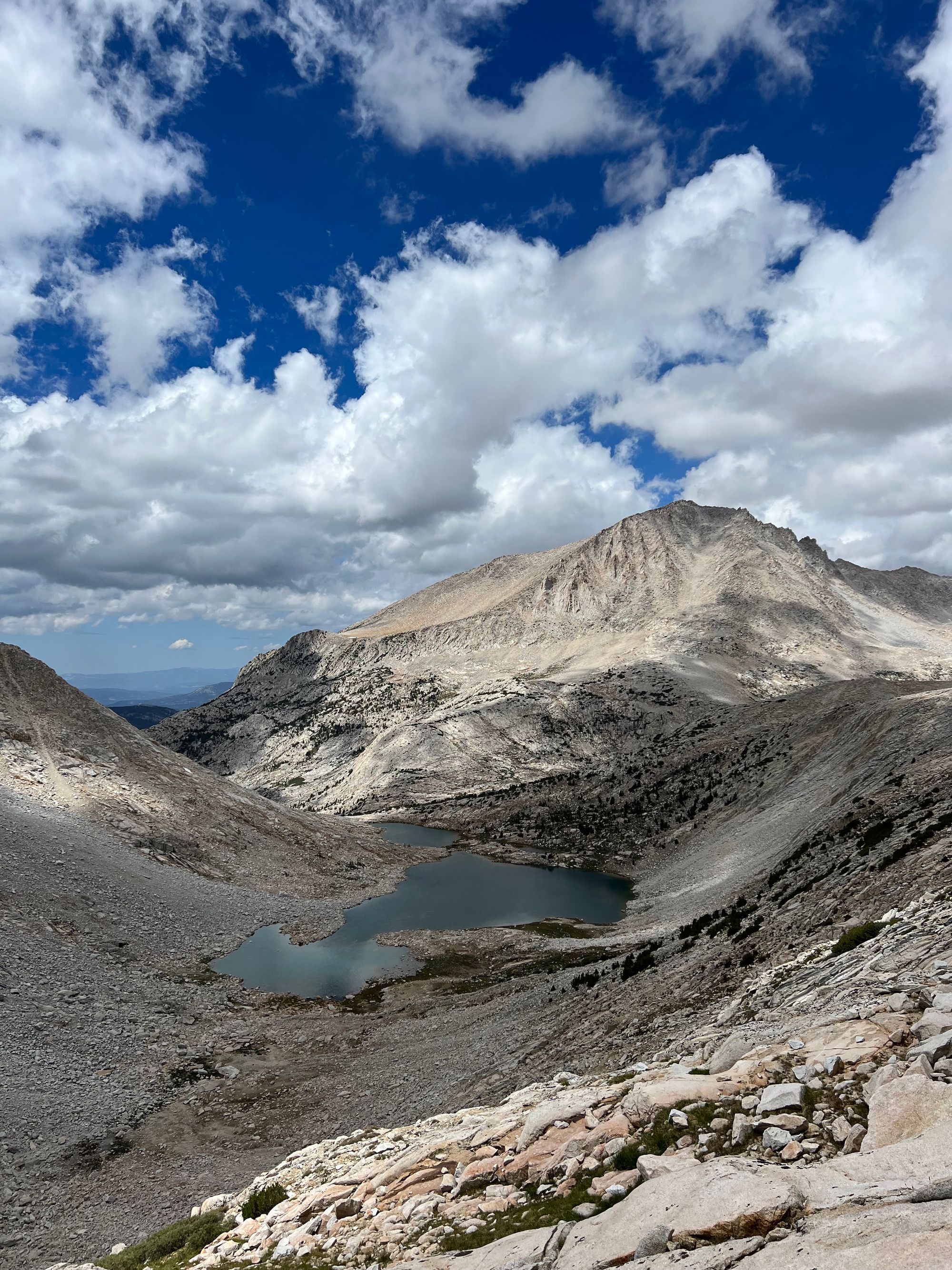 A blue lake nestled in a rocky bowl.