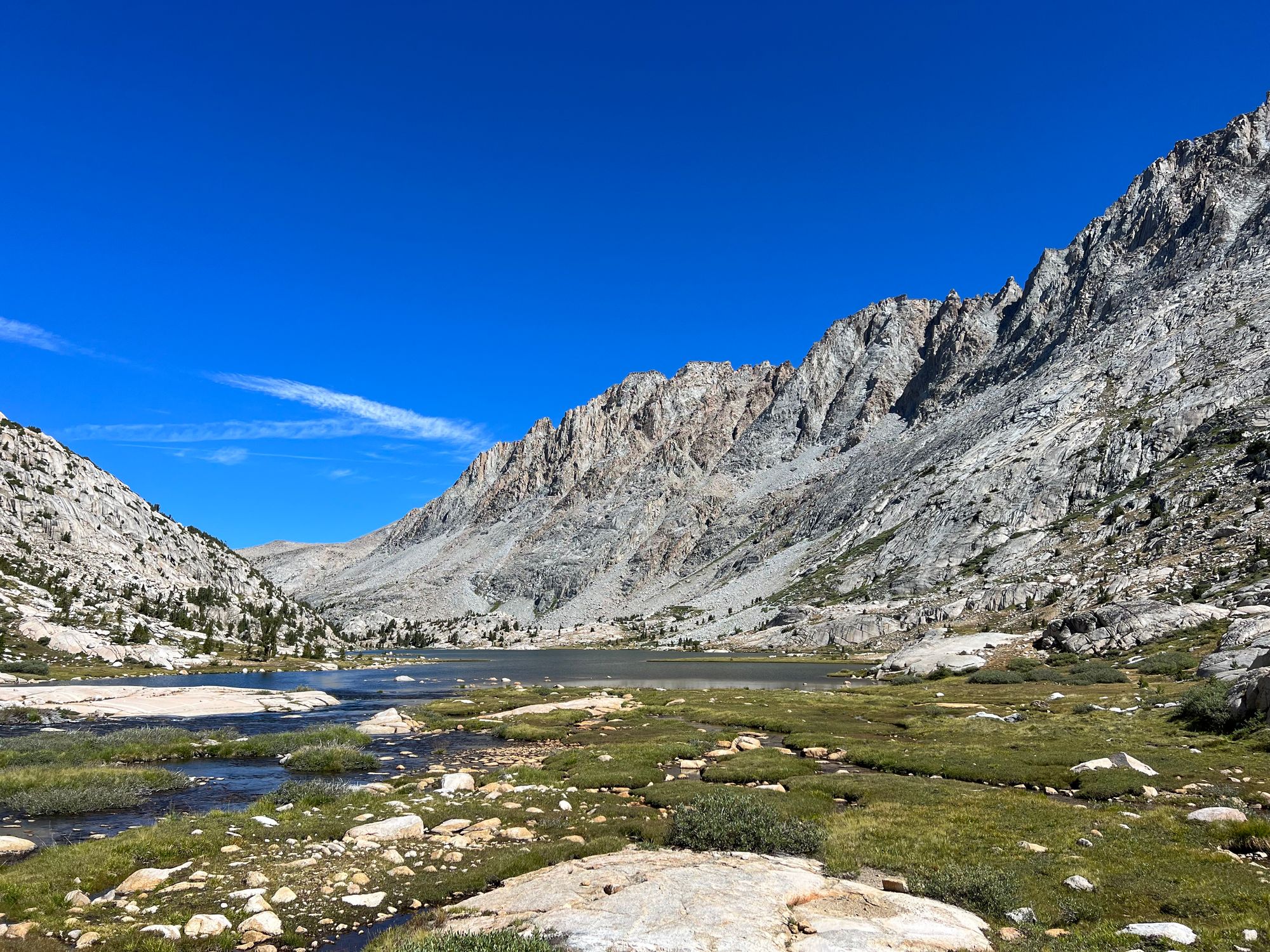 A jagged mountain ridgeline above a lake.
