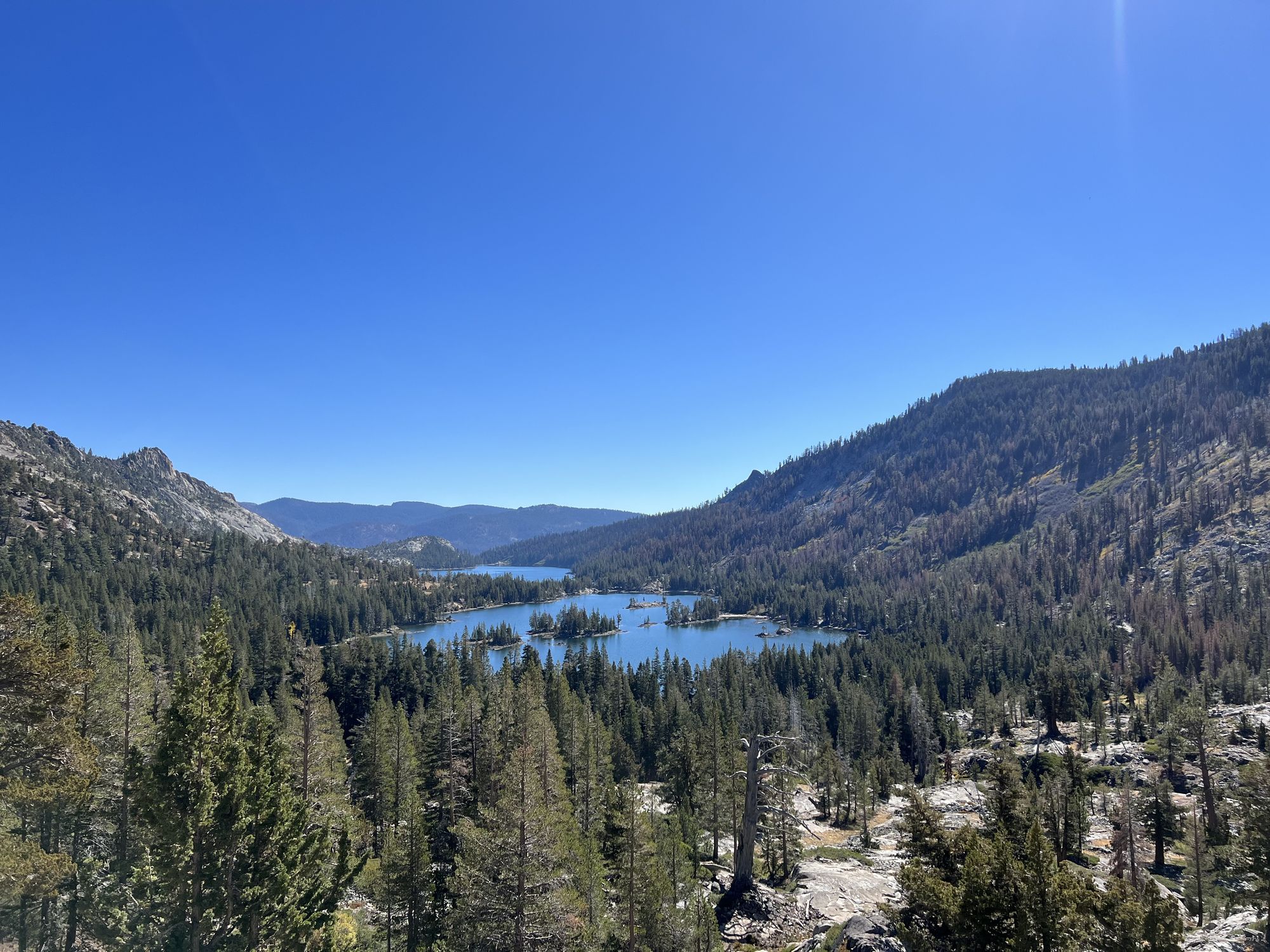 Two lakes in a forested mountain valley.