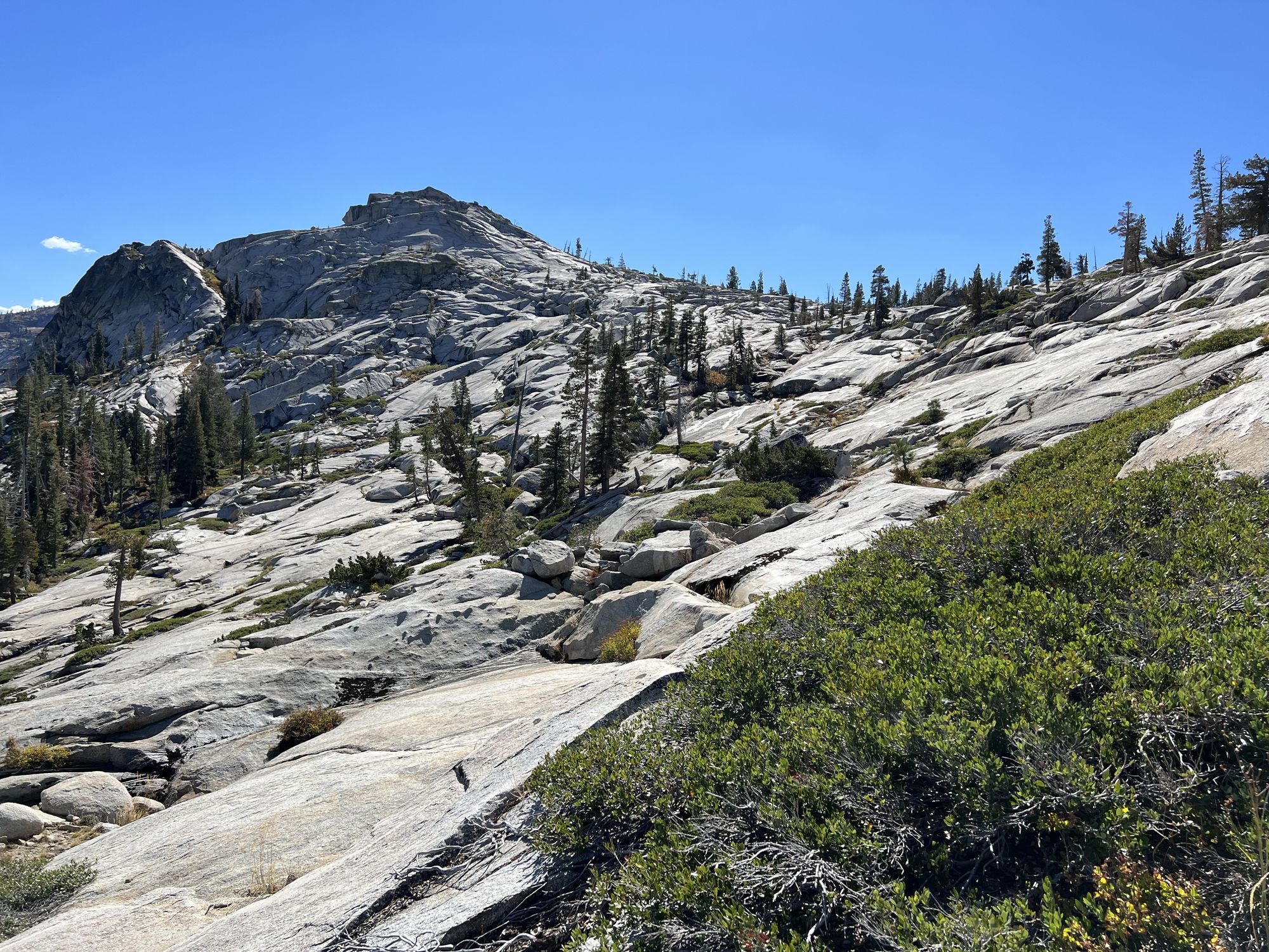 A smooth granite slab leading up to a saddle.