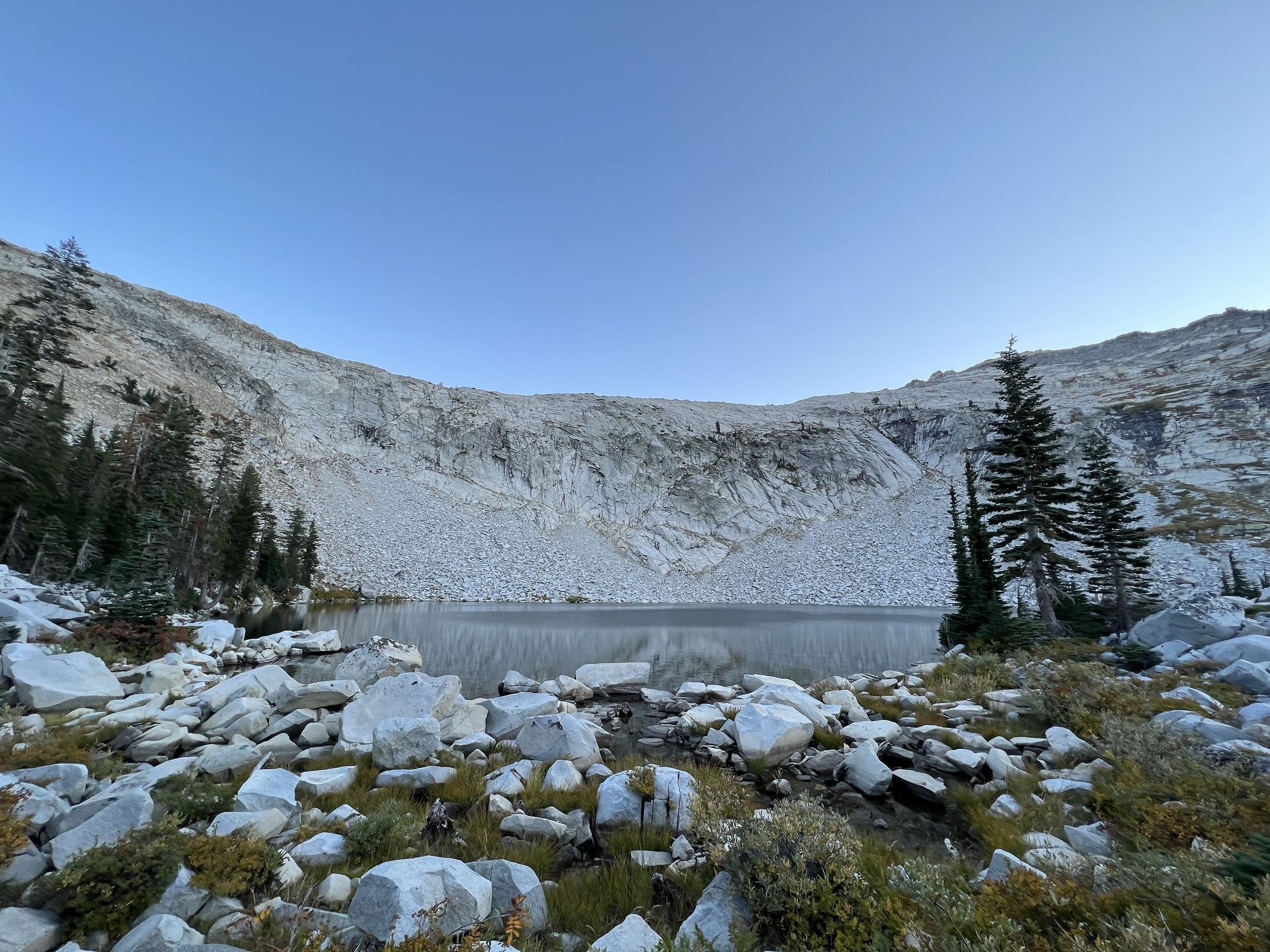 A boulder field leading up to a lake.