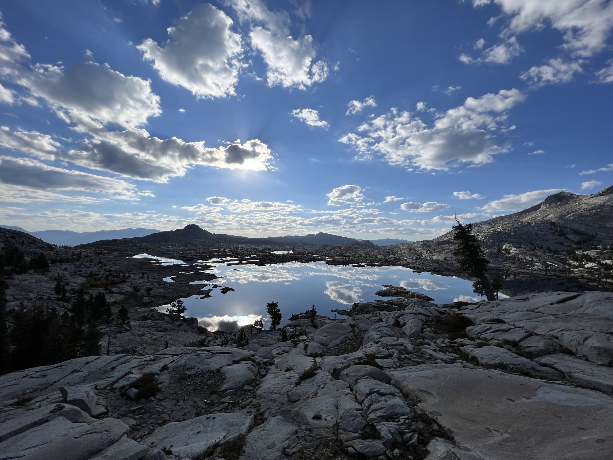 A rocky lake reflecting the sky.