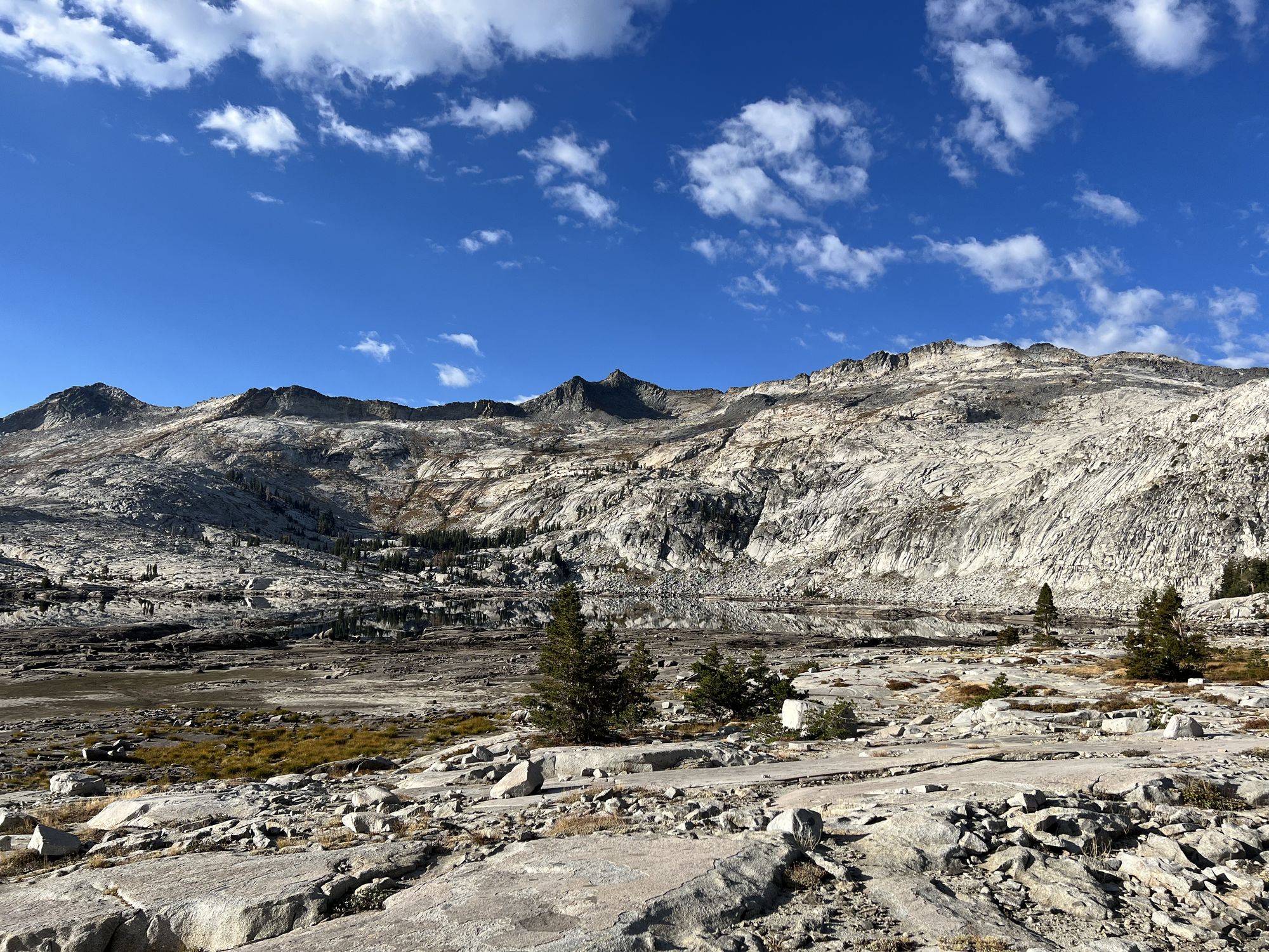 A lake reflecting the mountain on its other side, almost vanishing.