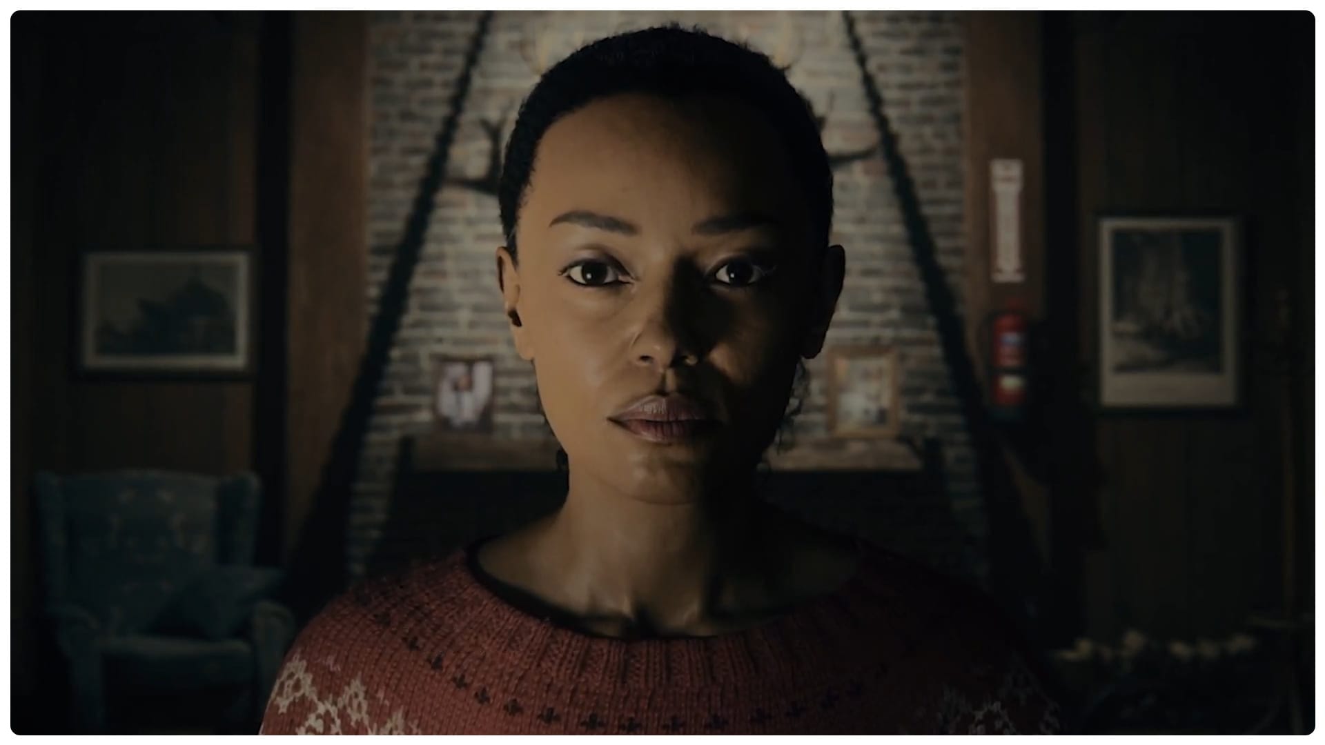 Saga Anderson co-protagonist of Alan Wake 2 stares with determination in her Mind Palace which resembles a lodge.