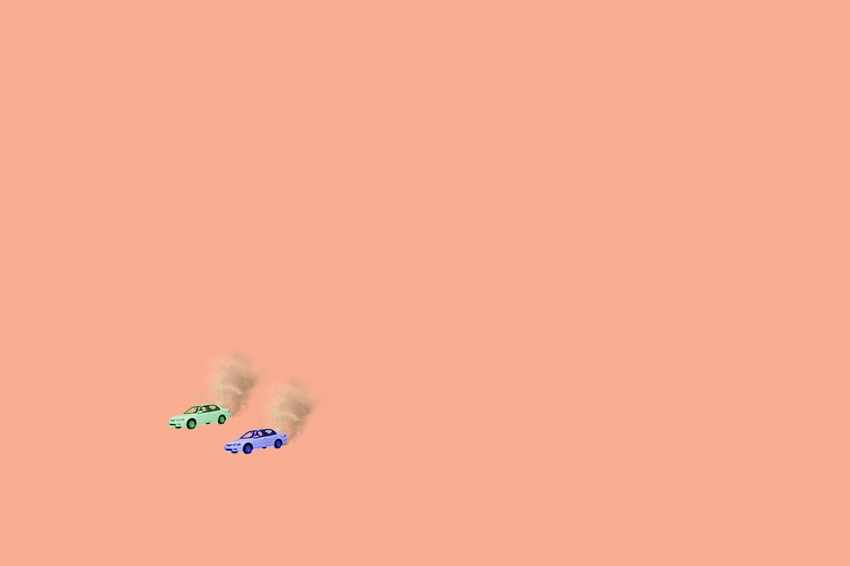 Two 2001 Toyota Corollas racing across a barren salt flat toward a land speed record