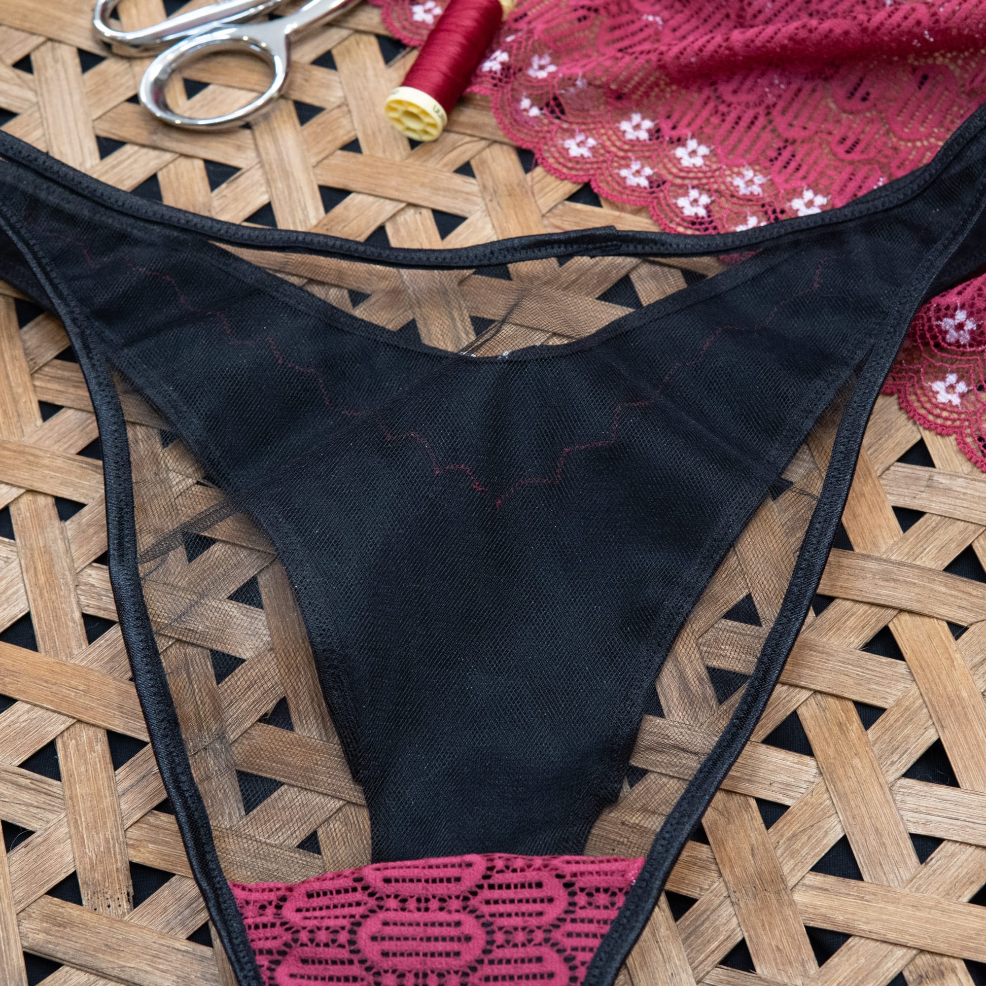 black mesh back of underwear with black FOE and red lace on the gusset