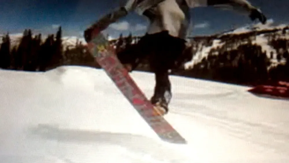 A pixellated image of a snowboarder executing a jump.