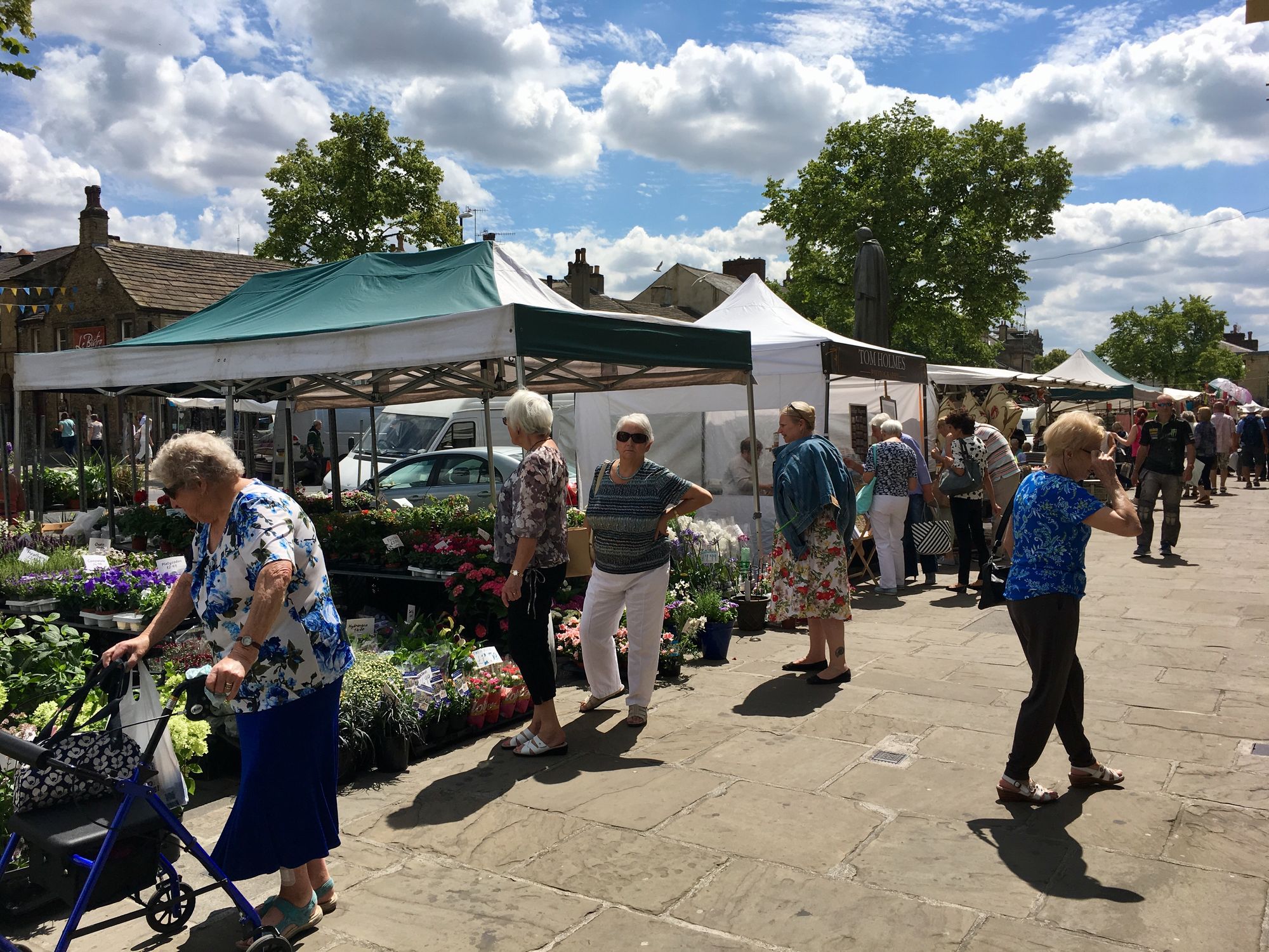 People walking through Skipton market