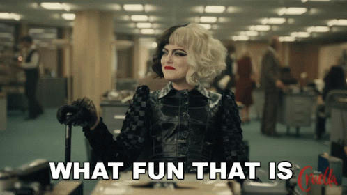 Emma Stone in Cruella. Full black costume, a cane, sitting across a desk, stating with a delightful expression "what fun that is".