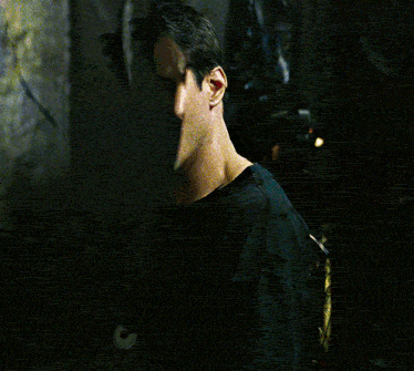 Neo looking into the broken mirror. His face fractured.