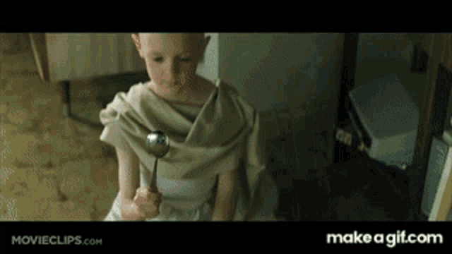 The kid holding the bending spoon. The small knowing smile.