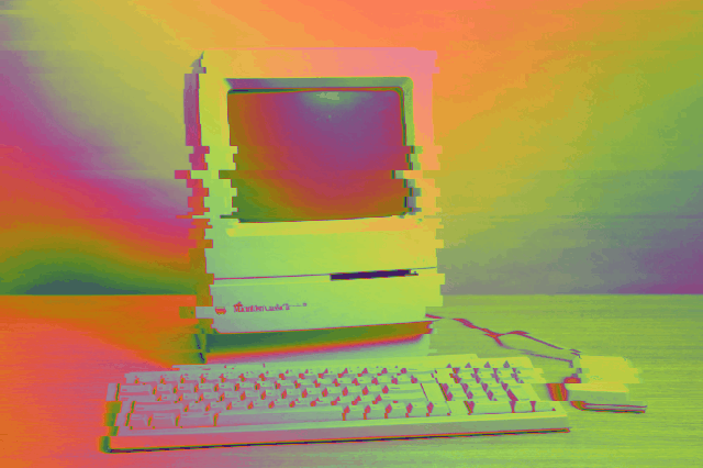 a glitchy rainbow animation of a mac classic ii
