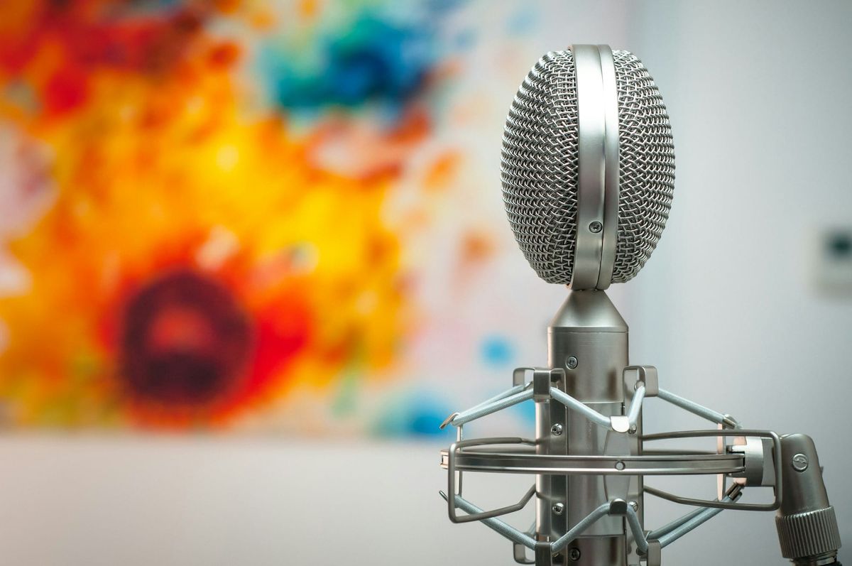 a silver microphone focused in the foreground