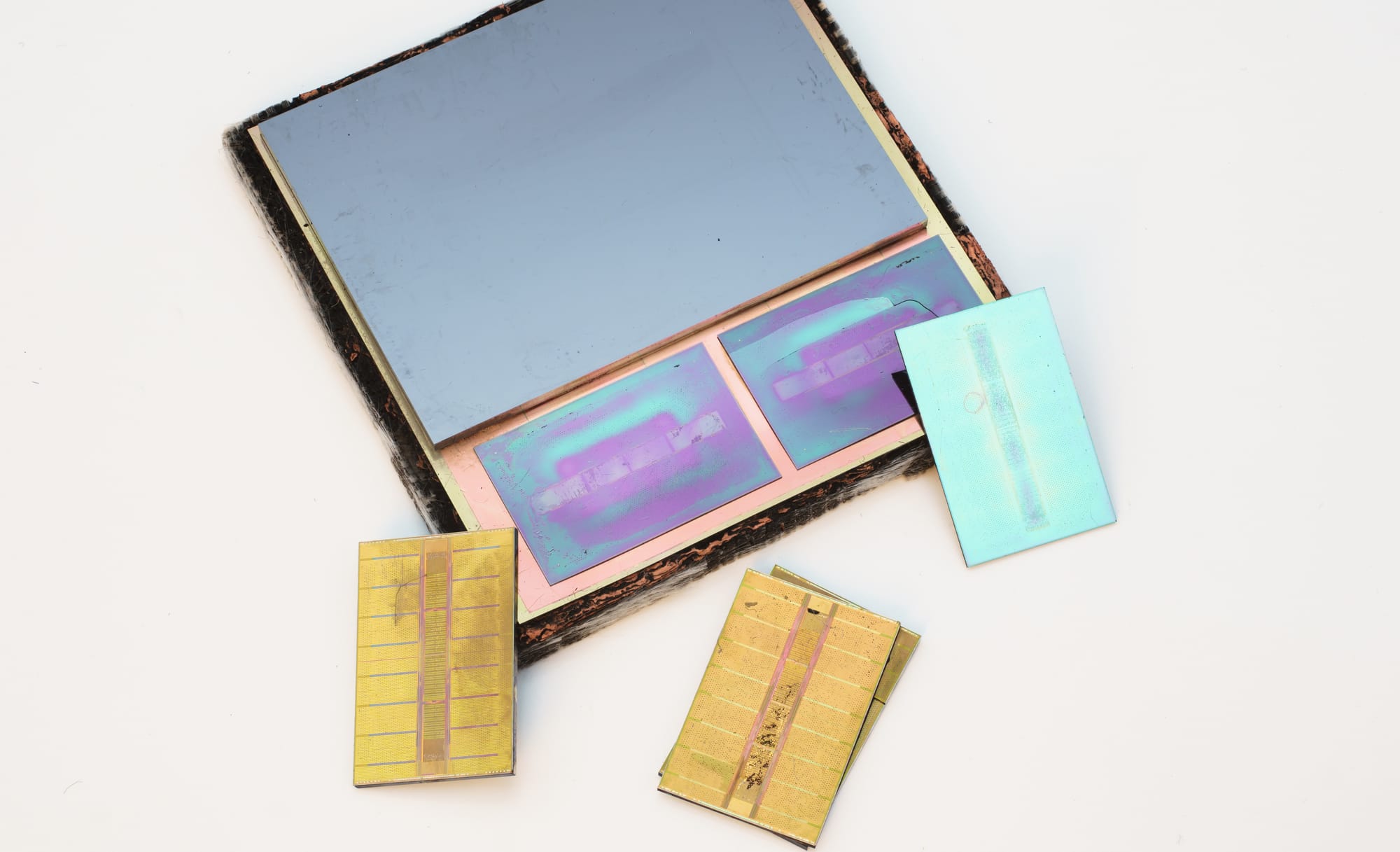The interposer of a Radeon RX Vega 64 with HBM2 dies removed: the dense passive silicon substrate that wires the compute die to the surrounding HBM stacks.