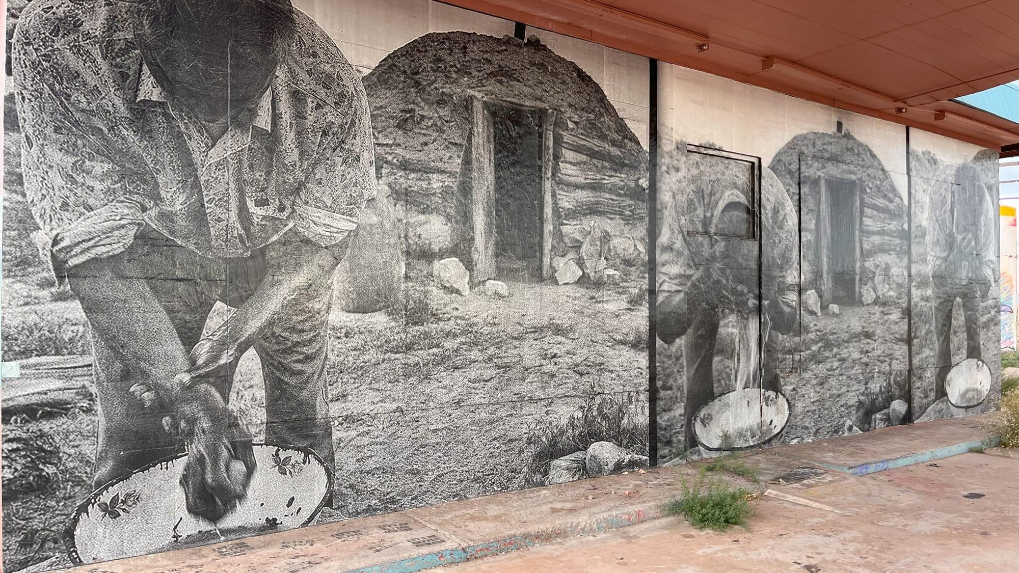 Black and white photos of a man washing his face and hands in a bowl standing in front of a Navajo hogan house of wood and mud.