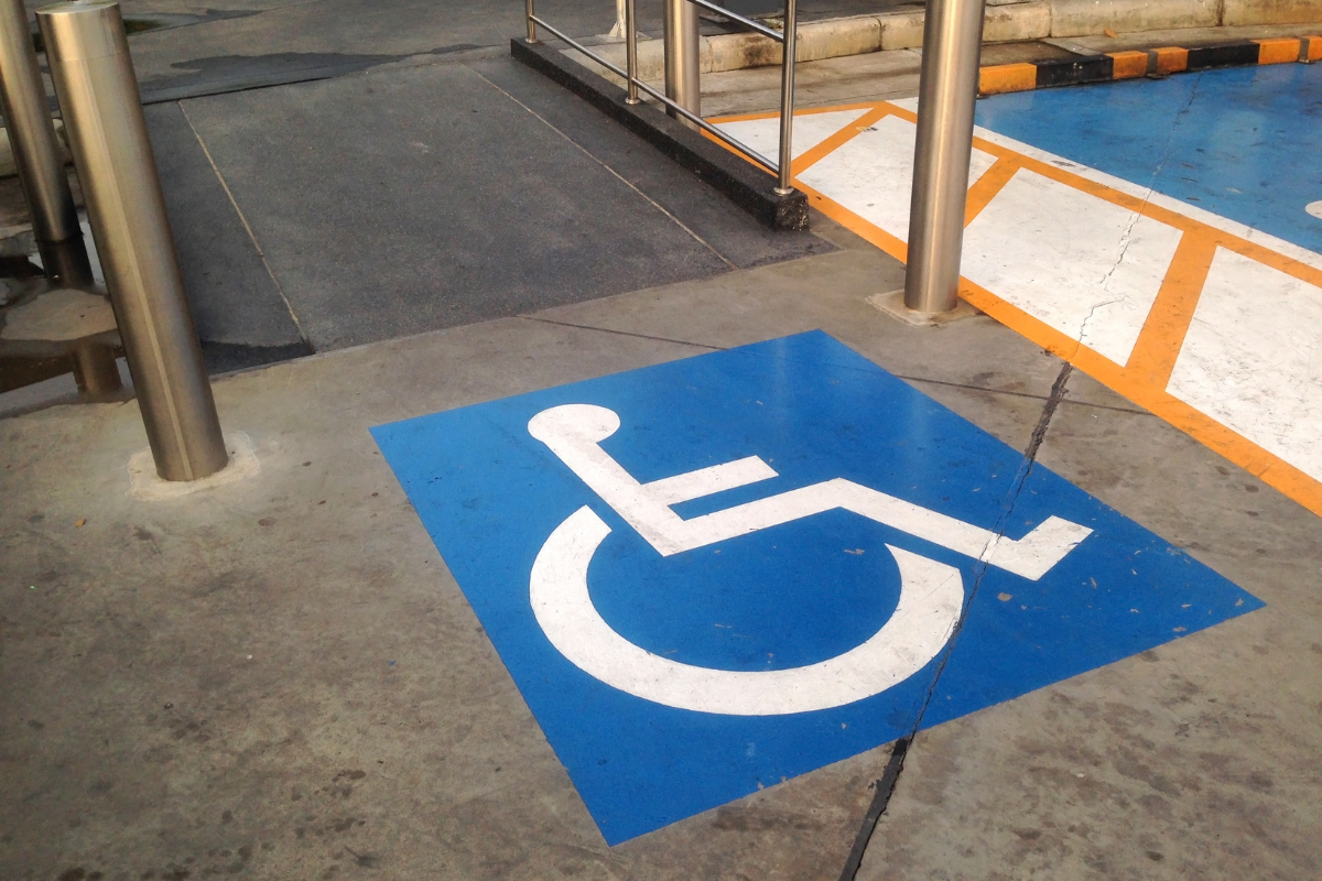 White on blue wheelchair symbol on an indoor floor