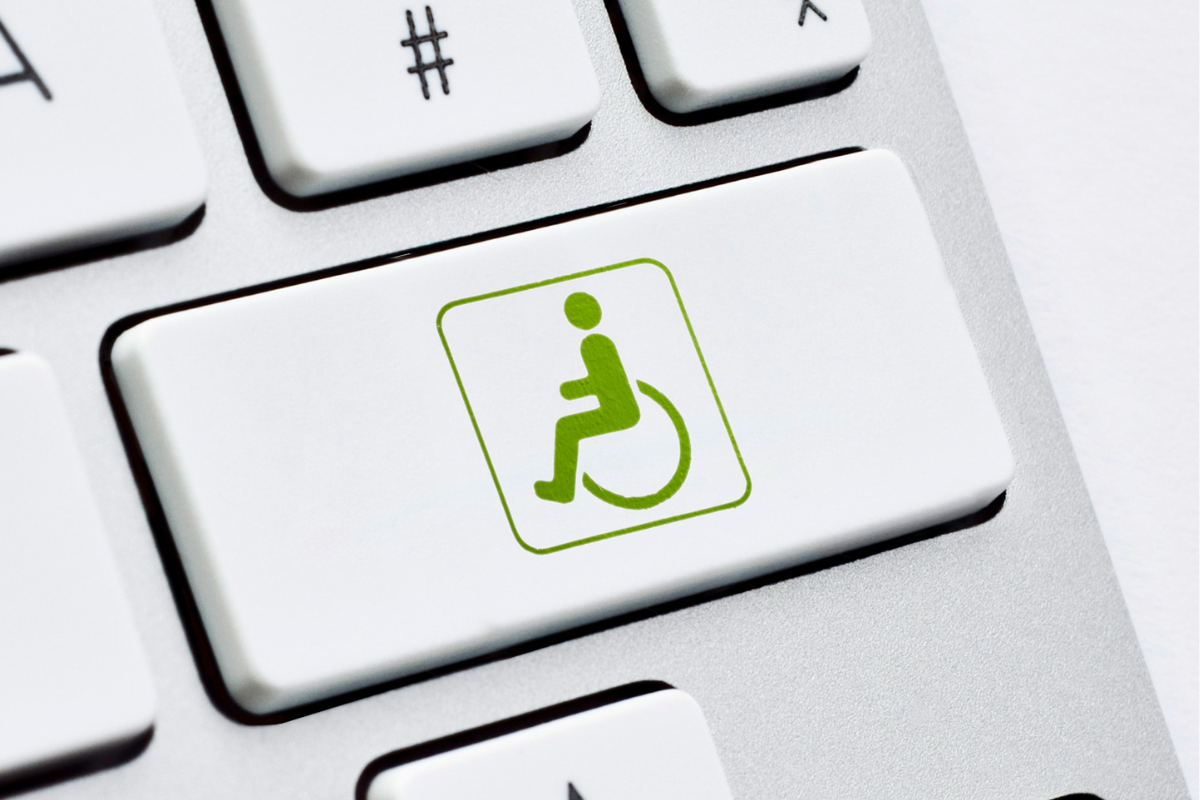 Green wheelchair symbol on a white computer keyboard key