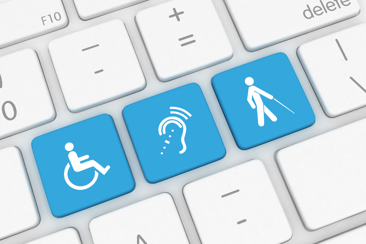 White wheelchair symbol, hearing aid symbol, and blind cane symbol on a row of three blue computer keys