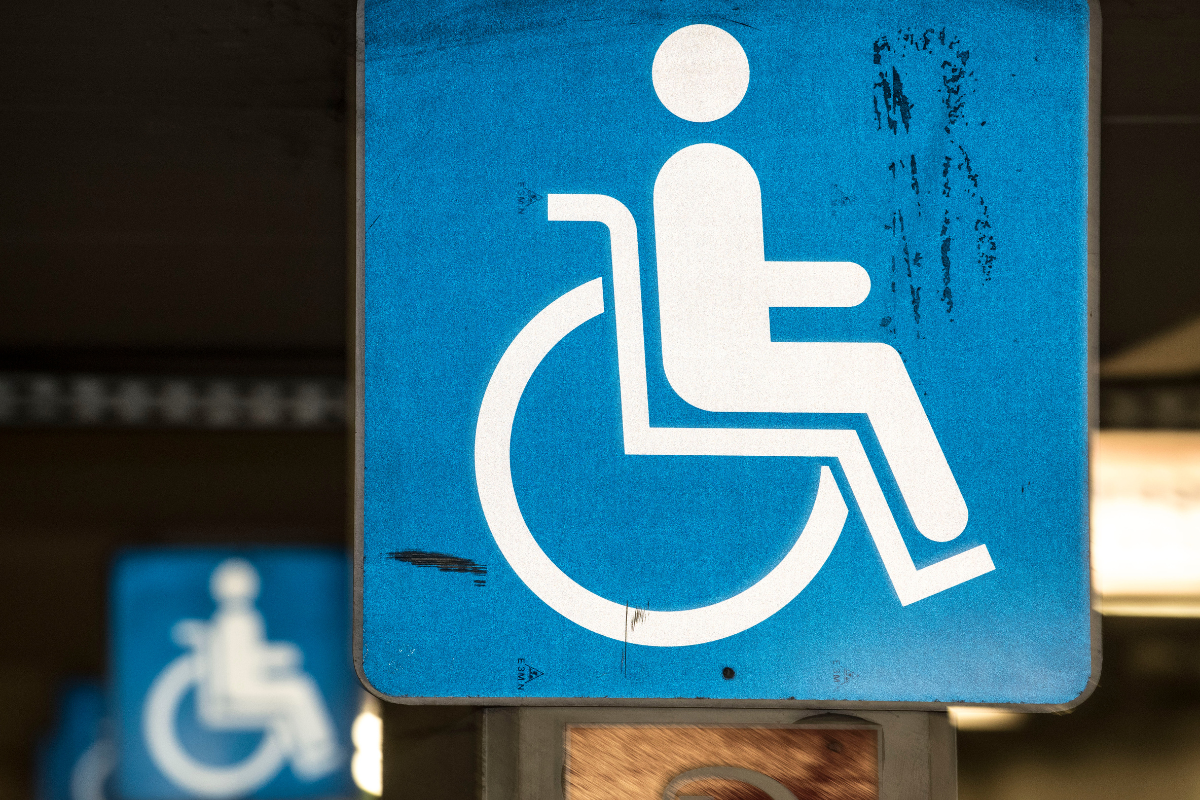 White on blue wheelchair symbol sign