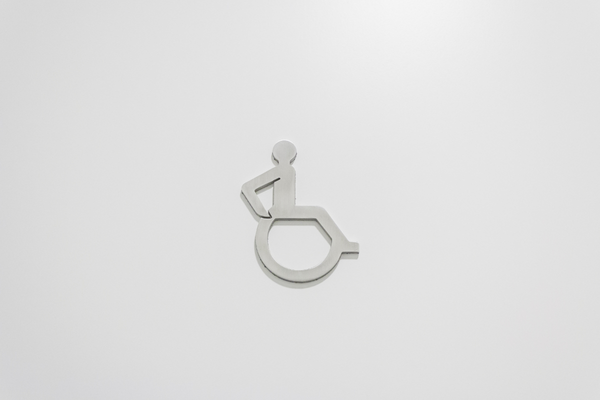 Grey wheelchair symbol on a light grey backgroun