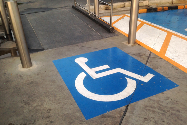 White on blue wheelchair symbol on an indoor floor