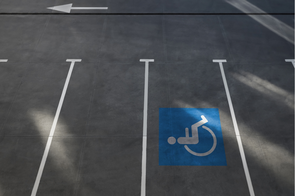 White on blue wheelchair symbol marking pavement of an accessible parking space