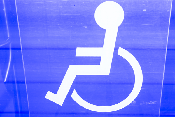 White wheelchair symbol on a blue background