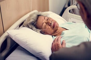 Elderly patient in hospital bed