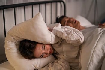 Person with sleep disorder snoring