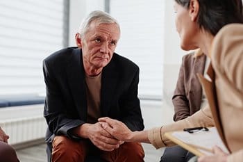Senior man at group therapy session