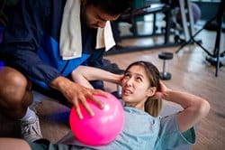 Trainer helping athlete with conditioning