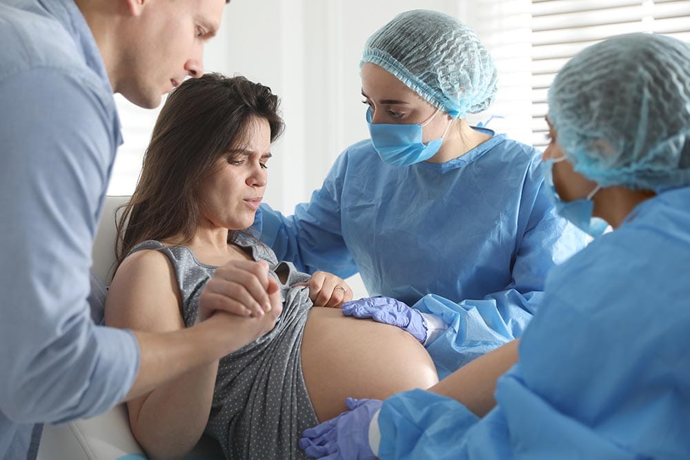 Woman in labor with nurses