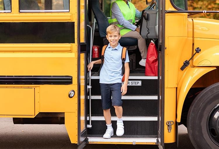 Child getting on school bus