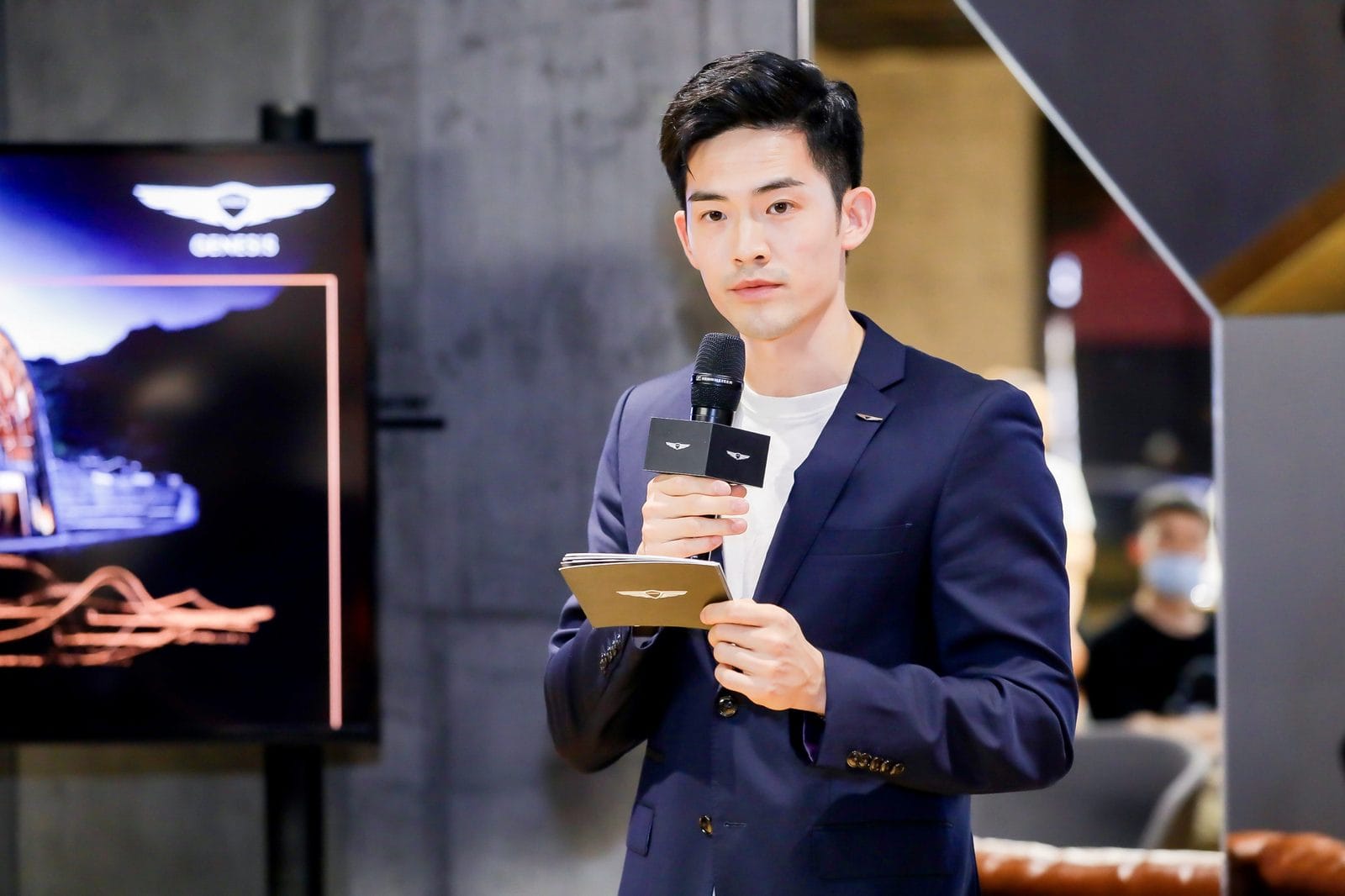 Martin Zhang hosting an event, microphone in hand