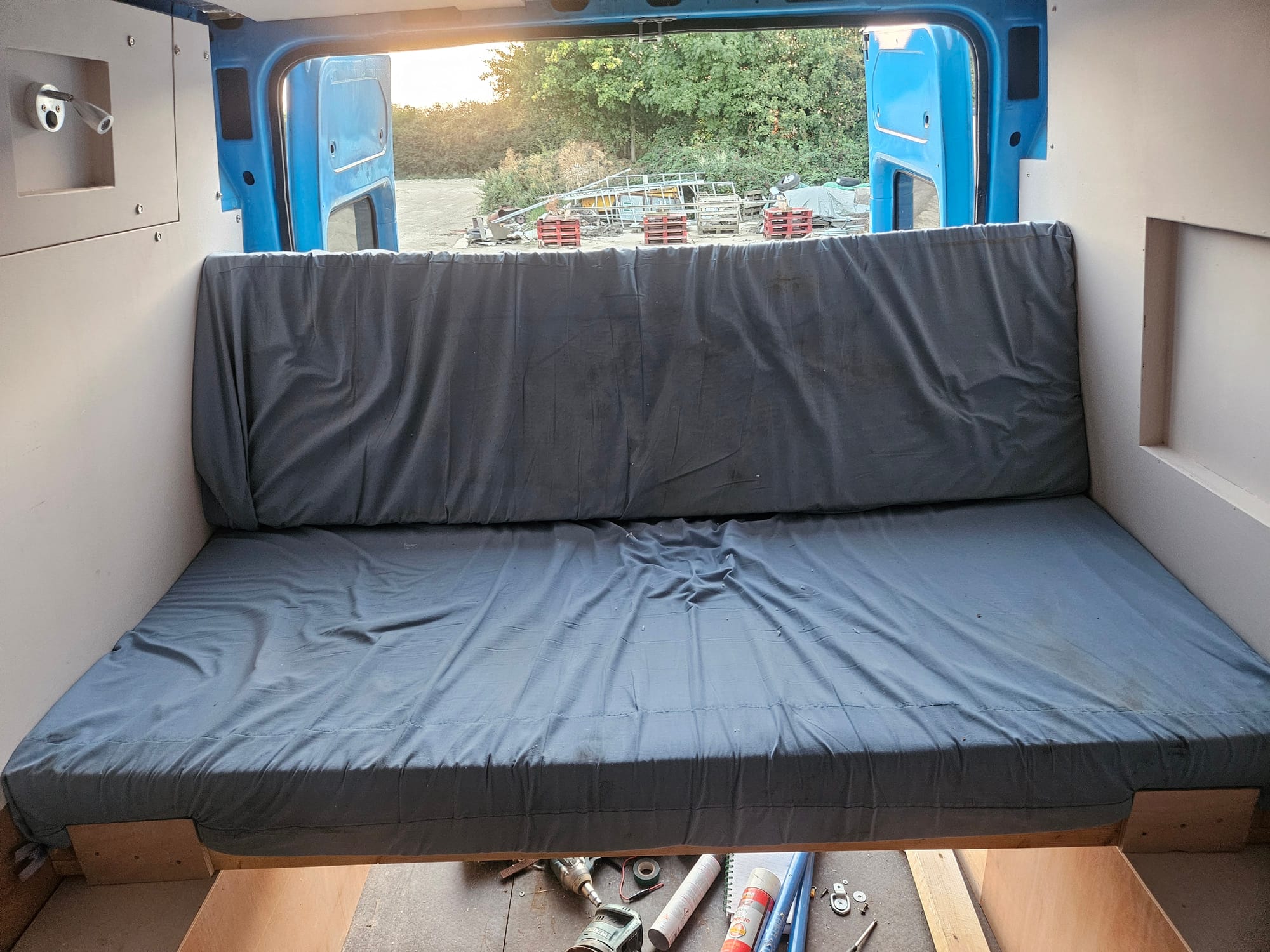 The bed inside the van, in the settee position 