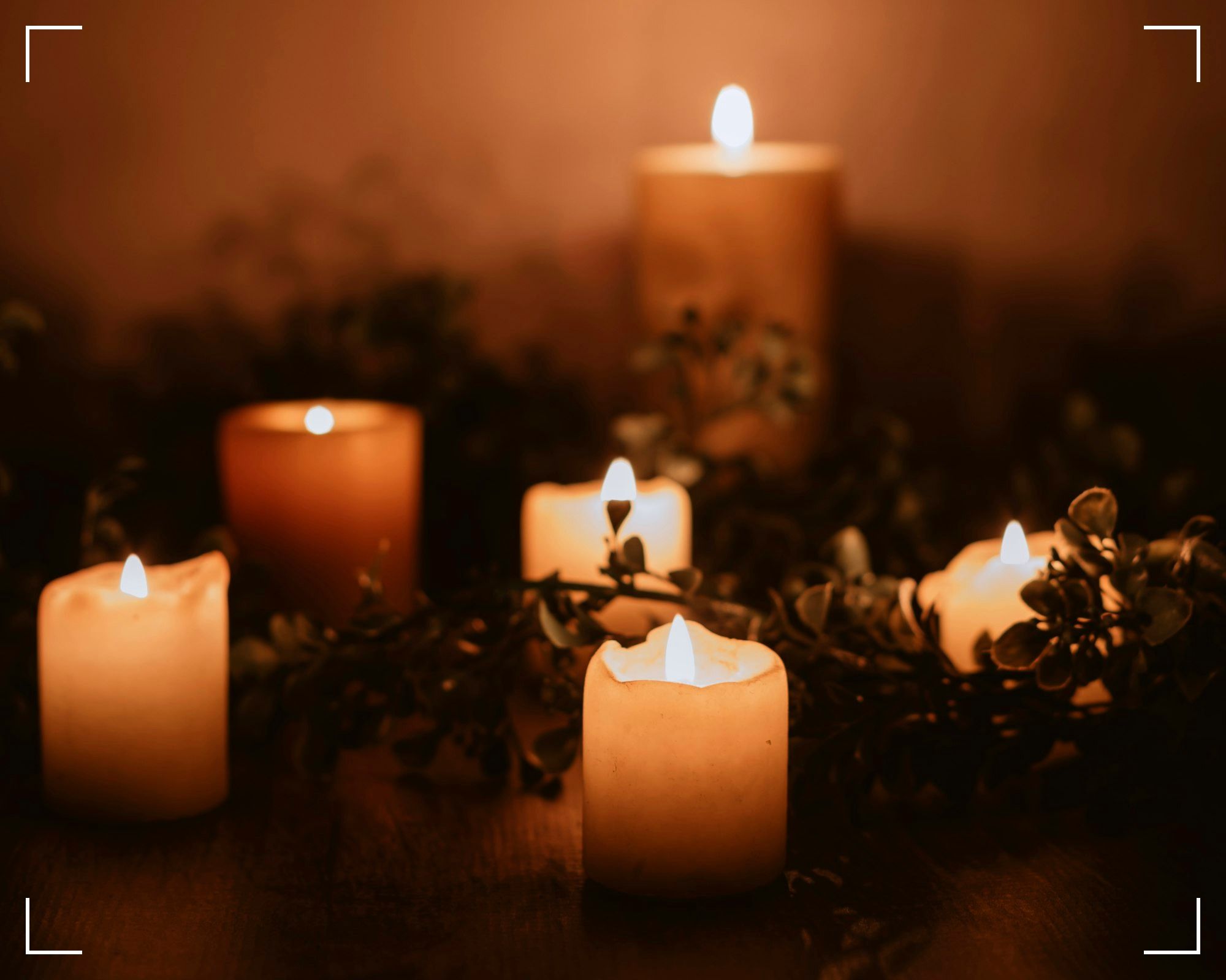 white pillar candle on brown wooden table