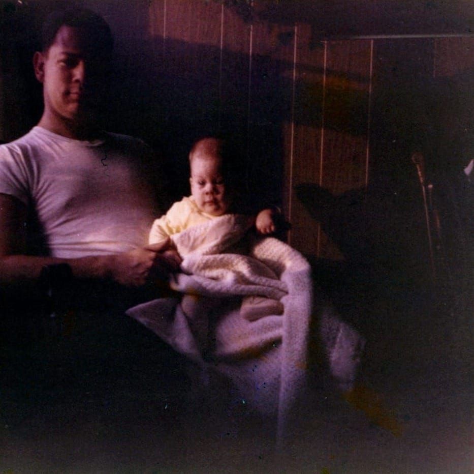 Father with baby daughter sitting on knee