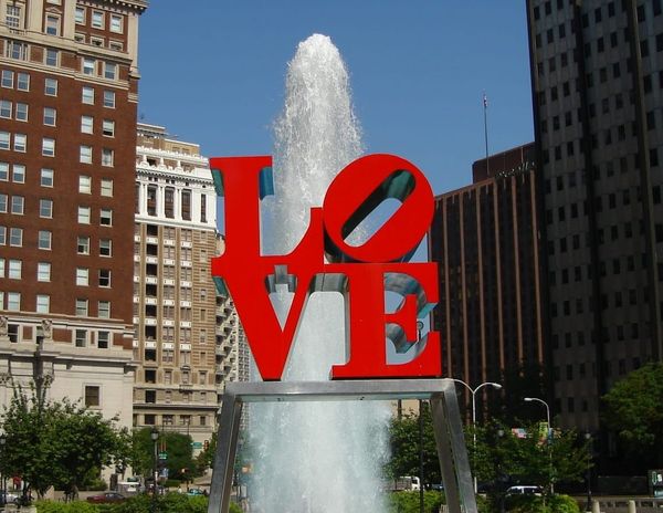 Love sculpture in front of fountain