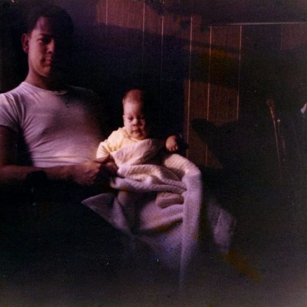 Father with baby daughter sitting on knee