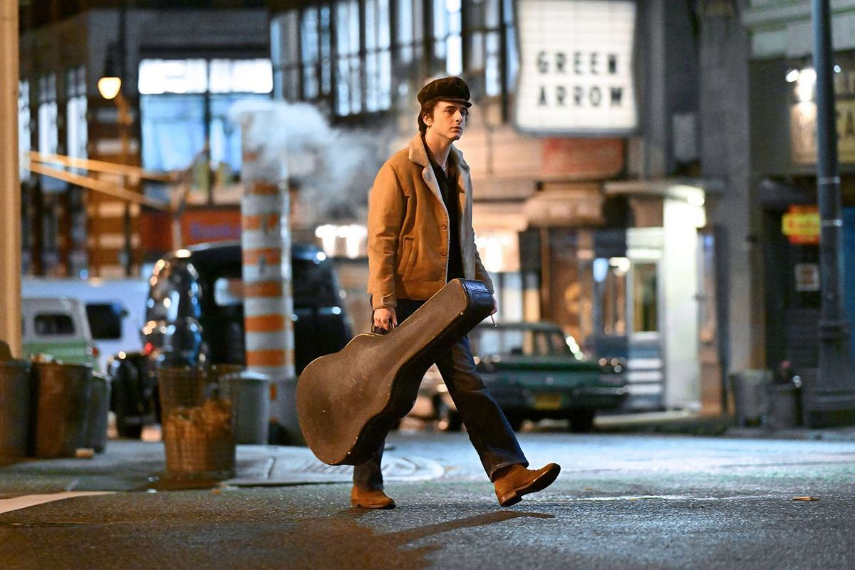 Timothée Chalamet walks through Greenwich Village in a still from the film A Complete Unknown