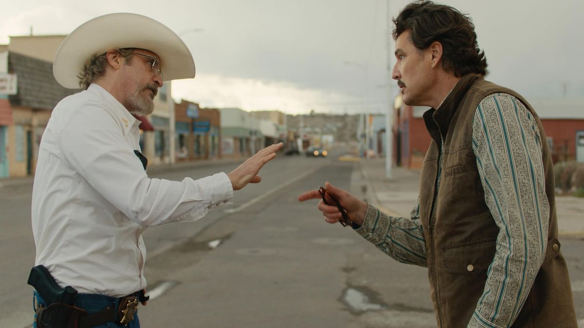 Joaquin Phoenix and Pedro Pascal in conversation in the film Eddington