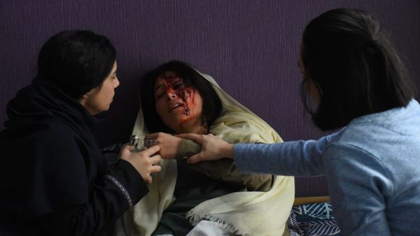 An injured student protestor receives care in a still from the film The Seed of the Sacred Fig