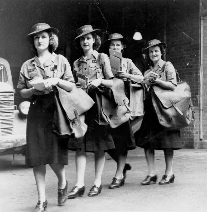 Postwomen with their mail bags and bundles of mail, Brisbane February 1943.