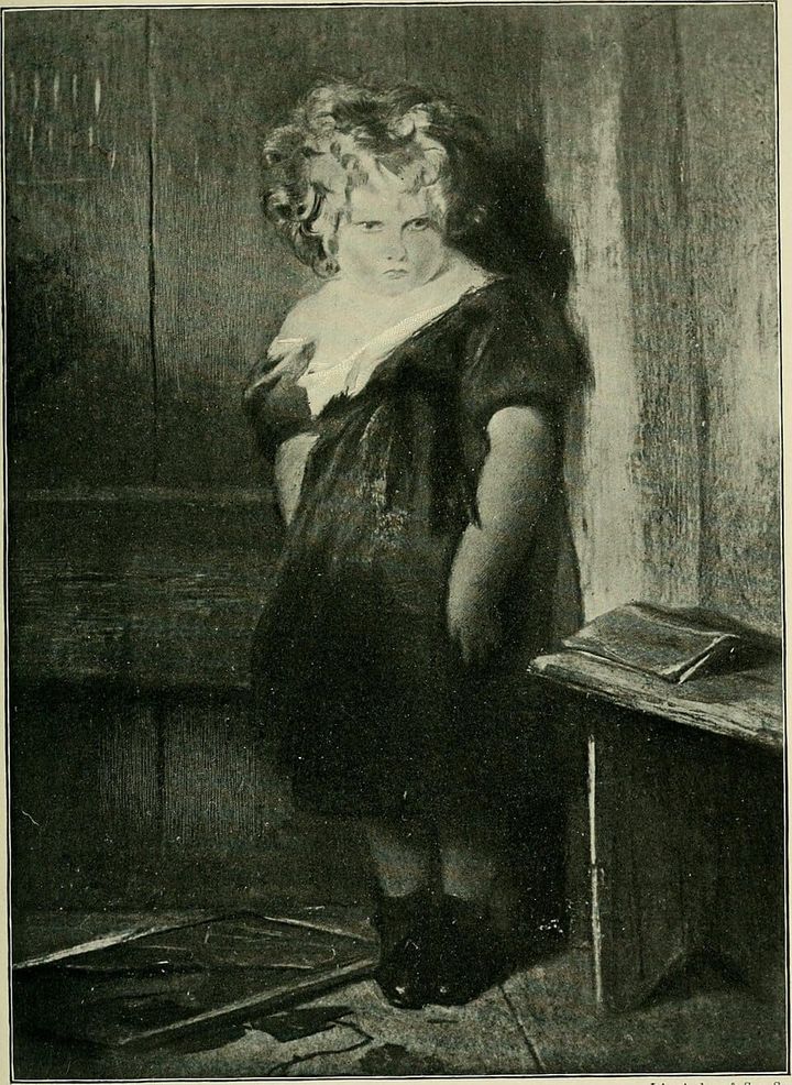 A portrait of a little girl in a black dress with a sour expression on her face. 