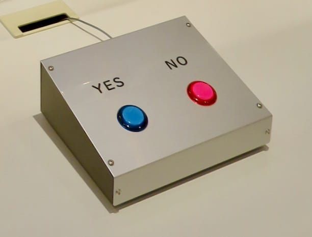 A metal box with a blue button for Yes and a red button for No.