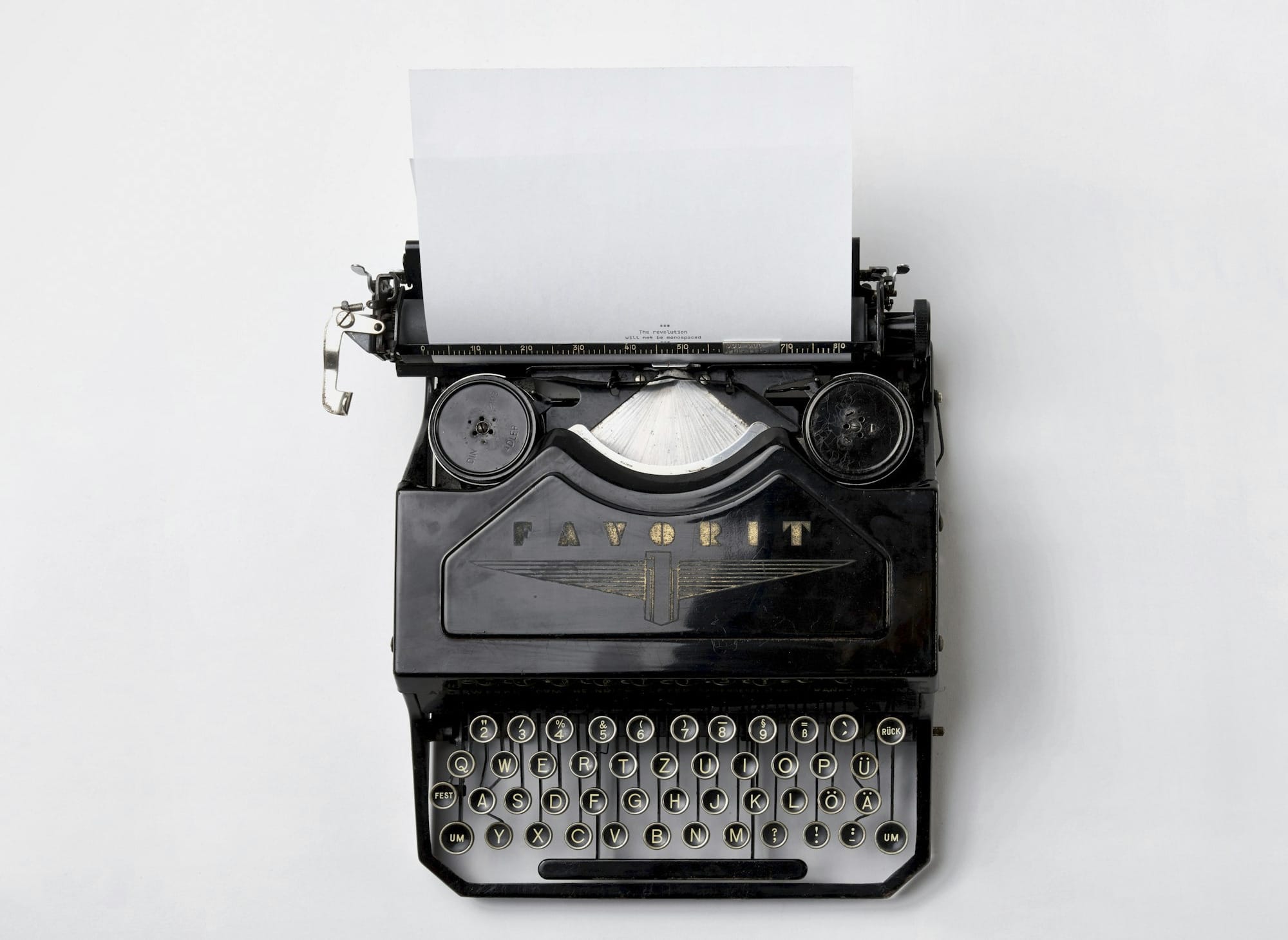 black Fayorit typewriter with printer paper