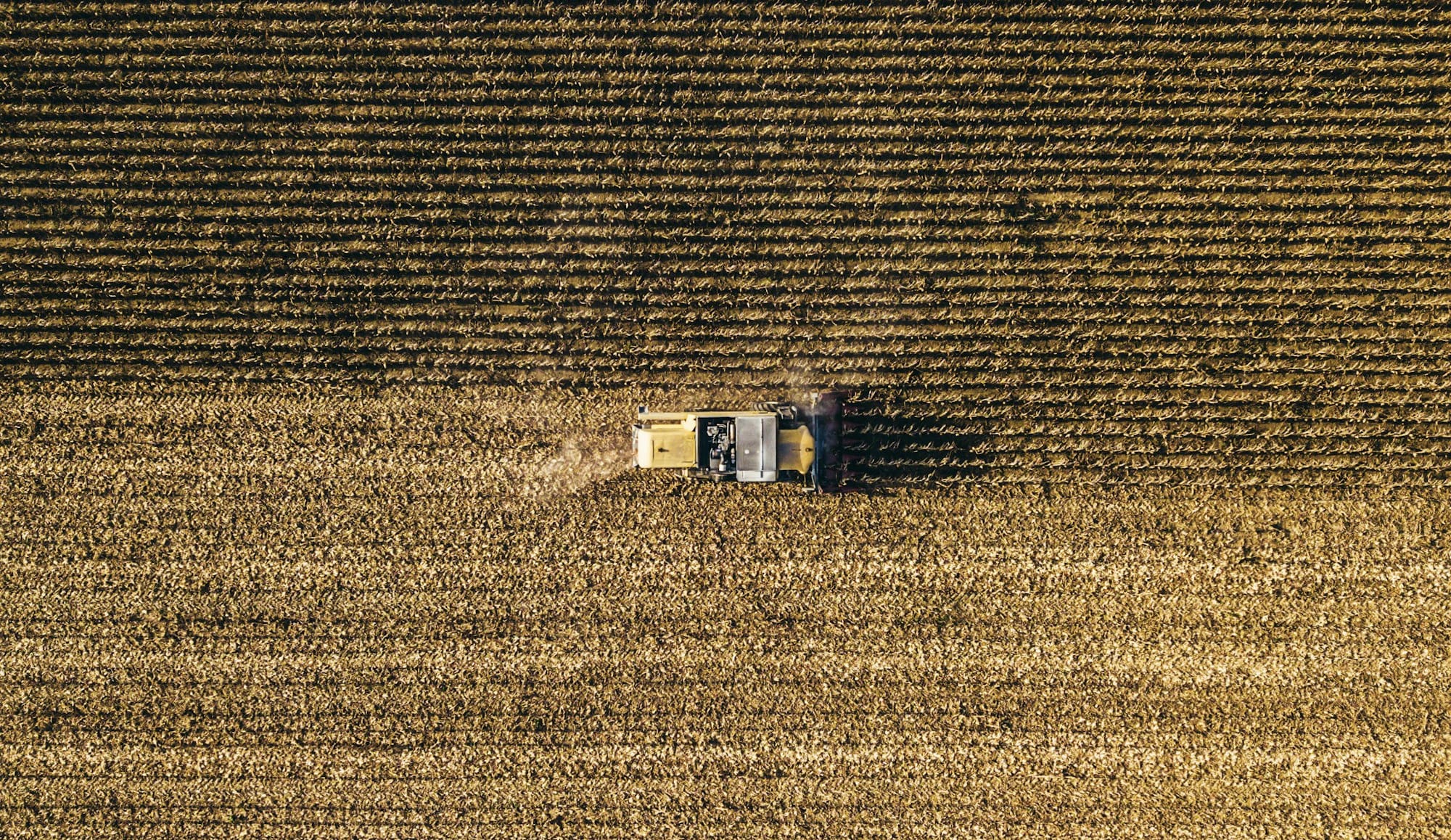 an aerial view of a farm house in a field