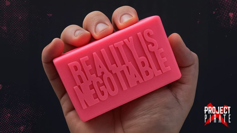 A pink soap bar embossed with the words "Reality Is Negotiable," styled as a Fight Club reference.